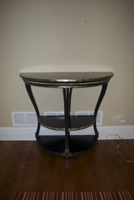 Black table with silver decorative accents 