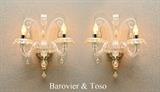 Lot 1018:  PAIR BAROVIER & TOSO ''RABAT'' MURANO SCONCES: Pair of 2 light electric Italian Venetian glass sconces in the Rabat pattern by Barovier & Toso with gold aventurine highlights. Overall measure 17 1/2'' h. x 13'' x 8''.
CONDITION: One has replacement center decorative arm in a leaf form.