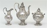 Lot 1047:  3 PIECE JOHN C. MOORE COIN SILVER COFFEE SET: 3 pieces total with repousse floral motifs with hallmarks for John C. Moore, New York, and J & I Cox. Circa early to mid 19th century. Pieces to include 1) Coffee pot with hinged lid, 11 1/2'' h. x 9''. 2) Covered sugar, 8 3/4'' h. x 6 3/4''. 3) Open creamer, 8 3/4'' h. x 5 1/4''. Monogrammed M. D. in shield on each piece. Approx. 79.8 troy oz.