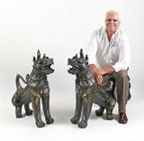 Lot 1062:  PR LARGE BRONZE TIBETAN TEMPLE LIONS: Similar, but not identical pair, each crouching forward with mouth agape. Each made of bronze with metal, mica and cabochon quartz jewel to breast bone, quartz eyes. Most likely early 20th century however actual age unknown. 34'' h. x 27'' x 13 3/4''.
CONDITION: Shippers note: Each approx. 125 lbs.