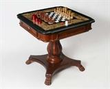 Lot 1211:  INLAID MARBLE CHESS TABLE: Late 20th century production, shaped inlaid marble top, drawer on either side holds chess and checker pieces. Base with carved acanthus leaf decoration on 4 carved paw feet. Overall measures 30'' h. x 30 1/2''.