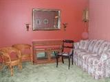 ratan chairs and curio cabinet, antique chair and floral sofa