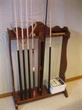 Pool table includes sticks and rack