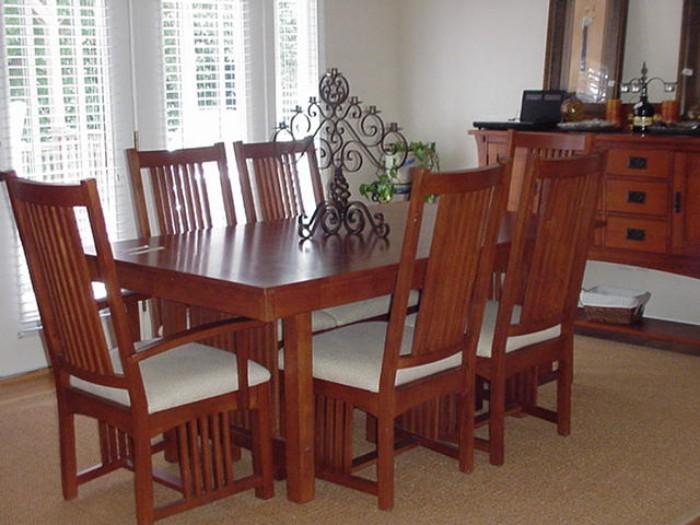 Mission style oak dining table and chairs, with matching oak buffet in background