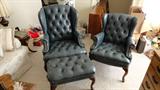 pait of matching blue leather arm chairs and foot stool
