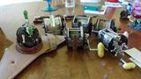 small group of fishing reels and rods. golf clubs