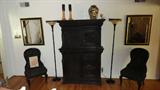 wall shot of of gothic chest, two victorian chiars to gold and black mirrors