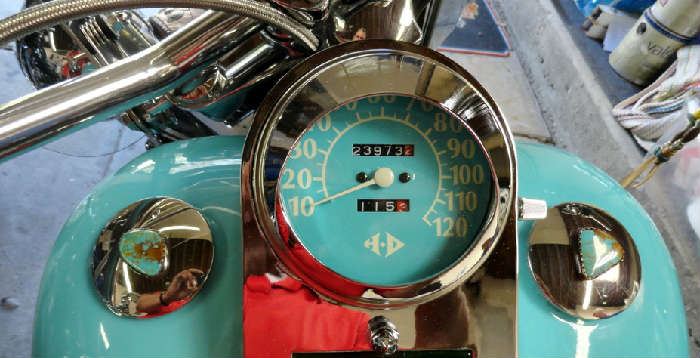 Speedometer and turquoise laden gas caps on Vintage tricked out customized southwestern style Harley Davidson motorcycle with 23,973.2 original miles @ www.crowncityestatesales.com.