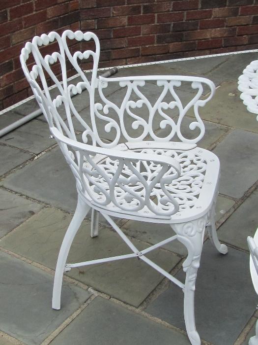 Detail of patio arm chairs.  There are three sets available which includes One 36 in round table, 4 arm chairs and umbrella.  They are White