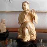 Mammoth Ivory figure of person playing flute, exquisite 