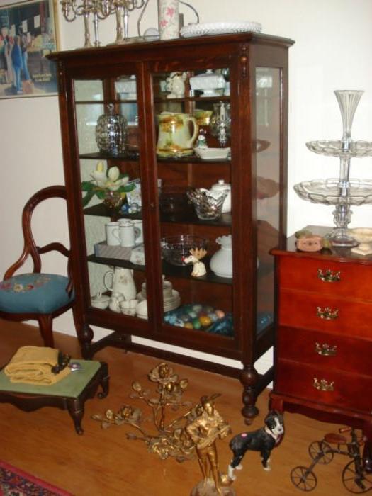 Display cabinet full of pretty glass and china
