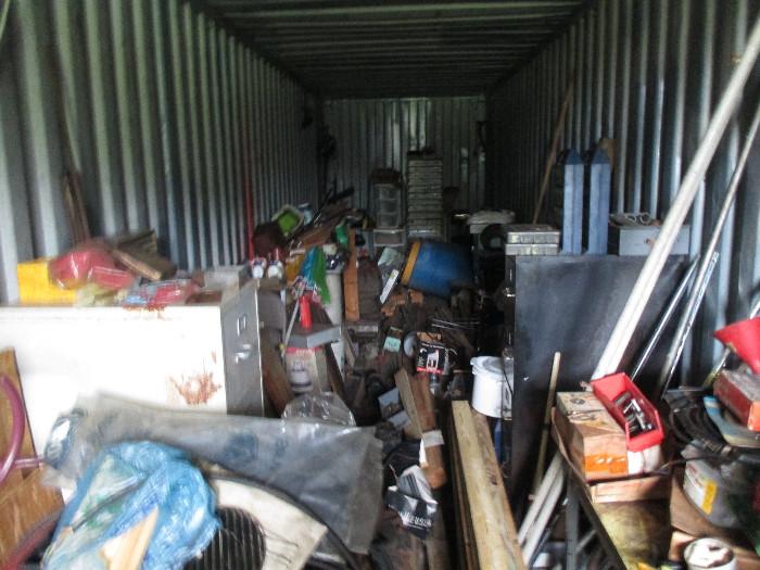A shipping container full of parts and tools and etc