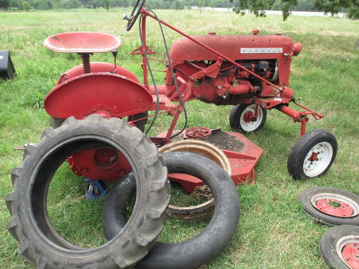 Farmall Cub Tractor.    The owner had it running up to last year then drained the tank.   He was recently in the process of patching one of the rear wheels.   The original front tire rims will go with the tractor.   The serial plate by the steering housing indicates it is a 1956 model.