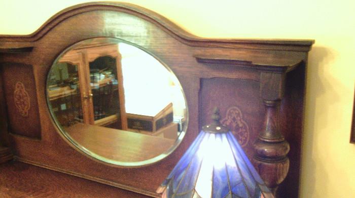 Wonderful mirror and side carvings on top of server!