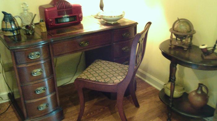 Nice desk with leather top.  Also, notice the red radio, pottery, pipe, china, and crystal.  On the right is a nice old half-moon table with accessories!