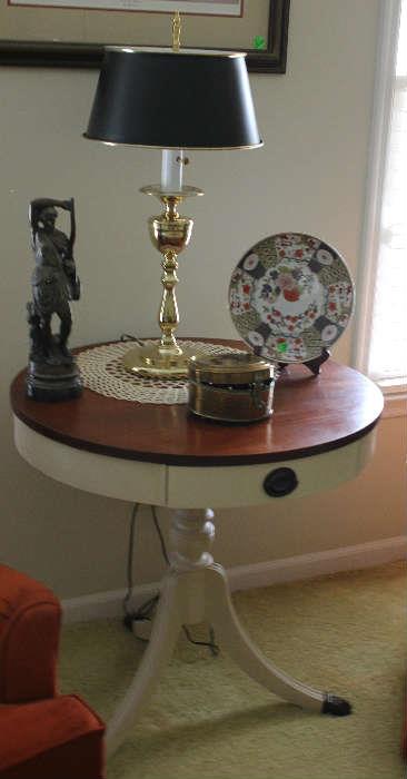 Distressed round table with mahogany top, with brass lamp and black round shade.  