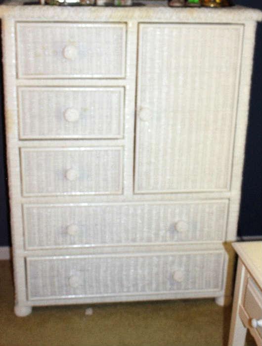 The white wicker chest that goes with the white and brass metal Queen size bed.