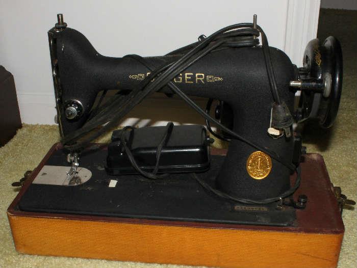 Very old Singer sewing machine.  There is also a Genie Singer sewing machine with attachments in this sale.  