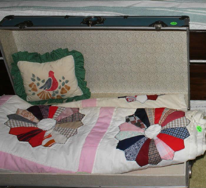 Hand made quilt in the blue trunk with shelf. Handmade pillow also.