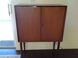 Teak liquor cabinet.  Lights up and has a mirrored inside