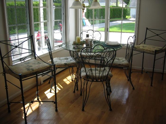 wrought iron glass top table with 4 chairs, 2 bars chairs in wrought iron