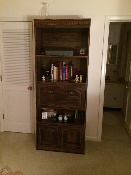 Dark stain shelf and cabinet combination. Center console folds out for writing.