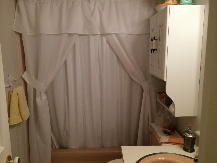 Very elegant white shower curtain with side drapes and valance.