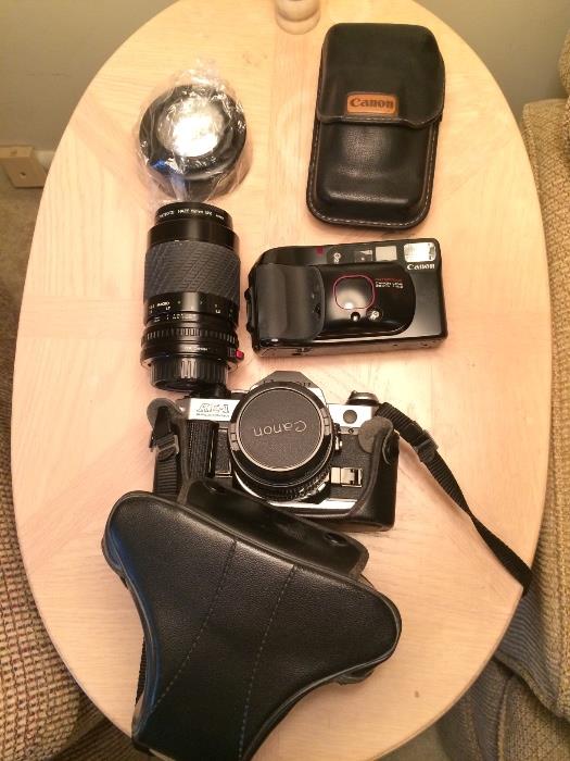 Canon AE1 film camera with case and telephoto lense. Also in photo Canon sure shot camera with case.