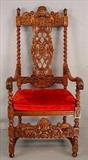 501 - Heavy carved fireside chair with barley twist and carved figurols with red upholstery