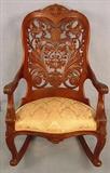 297 - Pierced carved back rocker and laminated. Made by George Henkle. 39.5 INT, 26.5INW (gold upolstery, walnut)