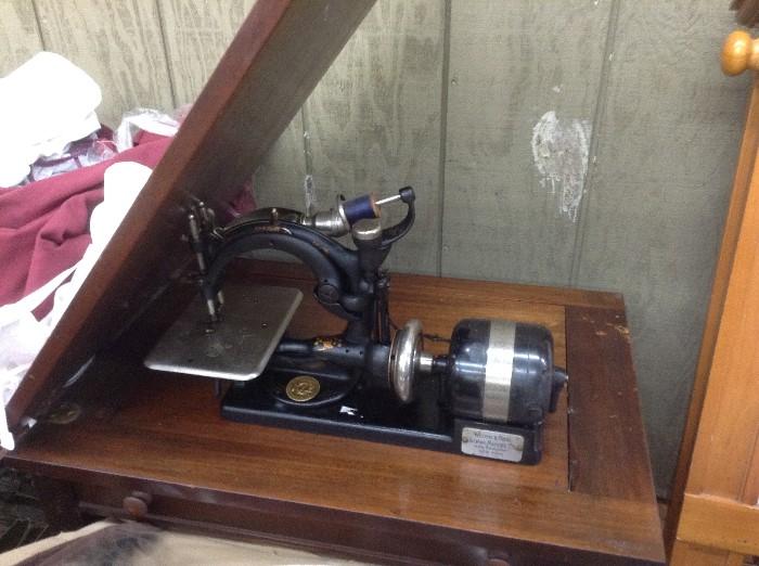 Old Wilcox sewing machine in stand