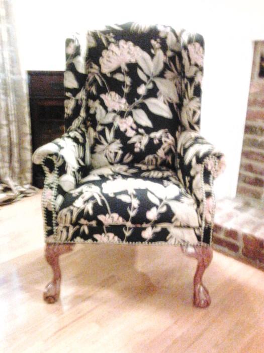 A pair of wing backed chairs. Stunning upholstery Black floral.  Ball and claw feet New Never sat in