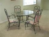 Round, glass top table with four chairs - $195