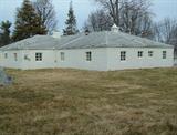 Back side shot of property w old block firepit