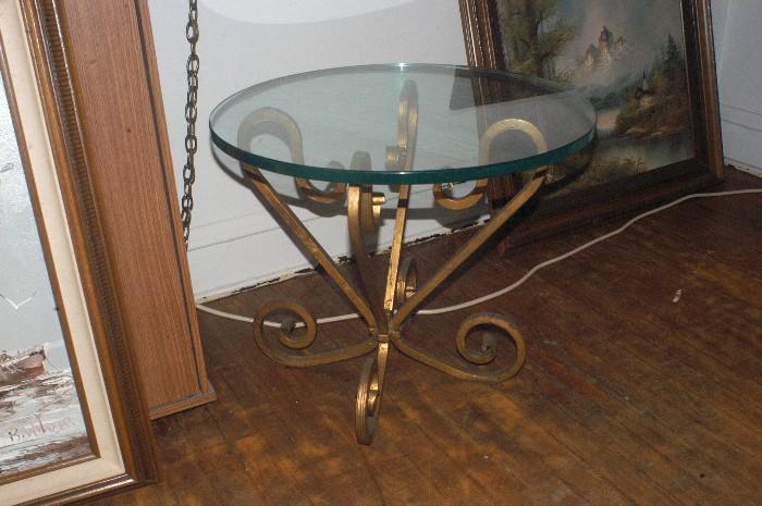 Glass top table with wrought iron base