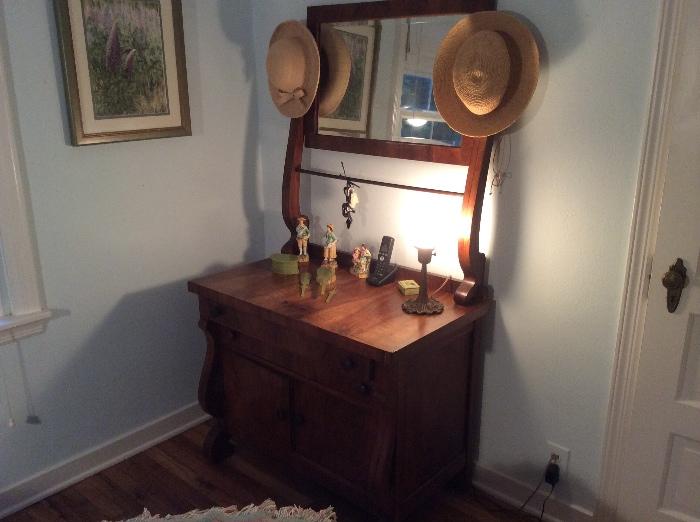 Washstand or dresser with mirror and towel bar.