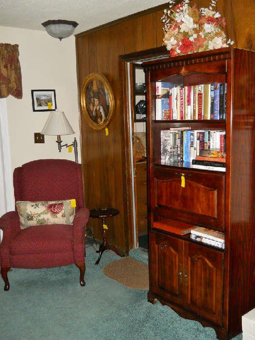 bookcase, books, recliner, side table, floor lamp, etc.