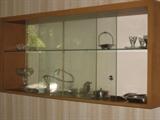 1950s floating display cabinet with glass shelf and glass sliding doors 56 wide, 13 deep, 25 tall.