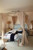 4 poster bed frame and bedding - bed has a lion that goes on the top of the canopy but it does not fit in this room.  Wrought Iron - silk bedding pale yellow and light blue