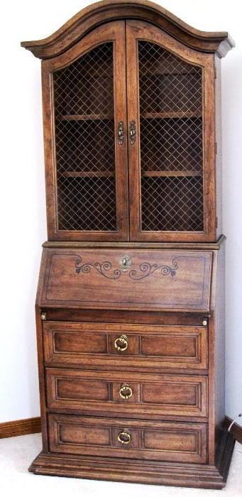 Hutch with drop front desk, 3 drawer storage with brass pulls, hutch top with double door shelves display / storage...hutch has nicely curved pediment, double doors have wire mesh, drop front has Stencil  floral  accents... walnut finish 