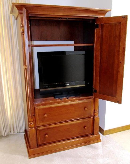 Traditional Style Armoire mfg by Bonavita... Armoire has double door cabinet   and 2 drawers storage, ...cherry finish.  Also shown is a Polaroid Flat Screen Color TV;