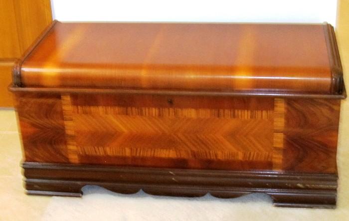 Vintage Art Deco Style Cedar Chest with beautiful rich color, nicely curved features and marketry accents.  Chest has large interior storage plus a top tray for small items storage.