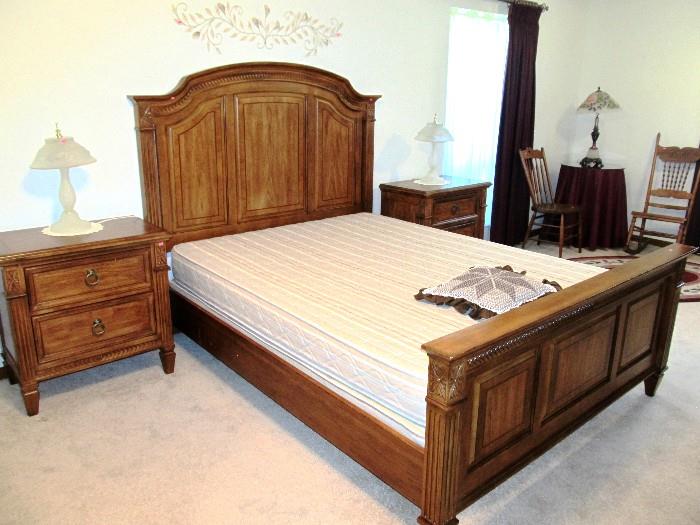 Continental Style Bed Set...Nicely Sculpted Queen Sized Headboard & Footboard with reeded legs, carved medallions and carved panels... walnut finish, Queen Size  Chiropractic Original Mattress & Boxsprings; Pair of Matching Night Stands with reeded legs, 2 drawers storage and brass pulls.  Bed Set and Night Stands are part of Continental Style Bedroom Set that also includes  Triple Dresser with Mirror, and  Large Wardrobes Armoire with beveled mirror door which are pictured elsewhere in this collection.  Also pictured is a Vintage Oak Rocking Chair with spindled back and an Oak Spindle Back Side Chair which are also available.  Accent Table Lamps shown are also available.
