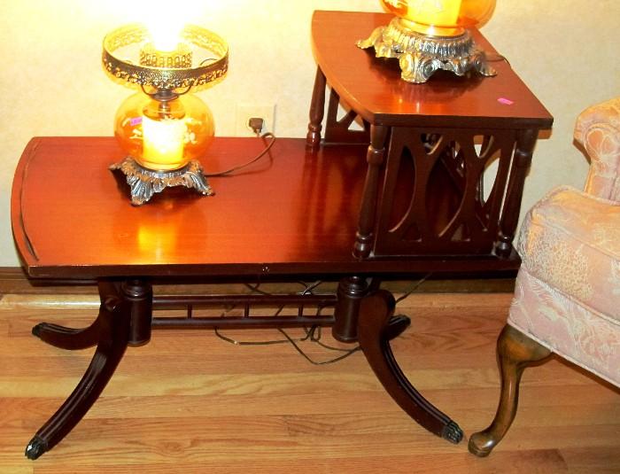 One of two Matching Vintage Duncan Phyfe Two Tiered Split shelf End Tables with mahogany finish, nicely cutout accents, brass paw feet; (the other Vintage matching Duncan Phyfe table is pictured elsewhere in this collection); The two vintage hurricane lamps are also available.