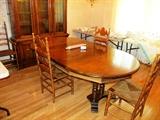 Drexel Dining Furniture... Drexel Dining Table, oval shaped, with 3 extra leaves, pedestal base, rich finish;  Drexel China Cabinet with glass & wood doored and shelves storage / display in the upper section, and bottom cabinet doored and drawers storage.  Also shown are 4 Vintage  Colonial Style  Oak Ladder Back Style Chairs (one arm chair, 3 side chairs) with rush seats, spindled legs, and oak finish; There are also a set of 5 Vintage Splat Back Style Dining Chairs with walnut finish and beige colored upholstery which are pictured elsewhere in this collection.