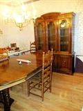 Drexel Dining Furniture... Drexel Dining Table, oval shaped, with 3 extra leaves, pedestal base, rich finish;  Drexel China Cabinet with glass & wood doored and shelves storage / display in the upper section, and bottom cabinet doored and drawers storage.  Also shown are 4 Vintage  Colonial Style  Oak Ladder Back Style Chairs (one arm chair, 3 side chairs) with rush seats, spindled legs, and oak finish; There are also a set of 5 Vintage Splat Back Style Dining Chairs with walnut finish and beige colored upholstery which are pictured elsewhere in this collection.