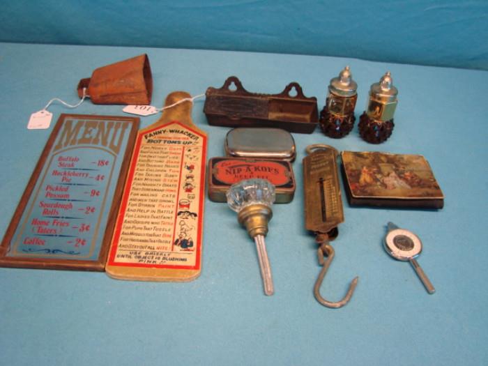 Lot includes: "Fanny Whacker" paddle, a glass menu mirror, a glass doorknob, some salt/pepper shakers, a coin purse, some tins, a pocket scale, and a cast-iron ash tray. 
