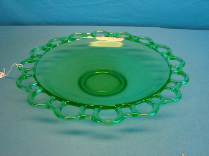 Beautiful modern uranium glass centerpiece bowl; Highly UV reactive piece, with a pierced pattern rim. Bowl has some moderate scratches, no chips or cracks. Measures 12 3/4" across.