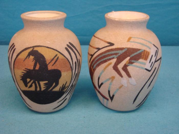 Two Navajo Indian sand art vases; Bottoms are signed, and both some with original tag, "Rancho Feliz, New Mexico, USA". Both are in excellent condition, and each piece stands 6" tall.