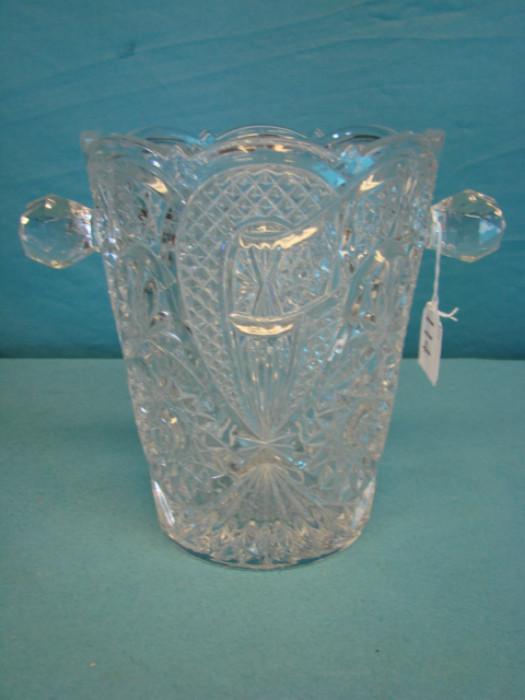 Beautiful pressed crystal ice bucket with handles; Very nice pattern throughout piece. In excellent condition, has some light wear on the bottom. Stands 8 3/4" tall.